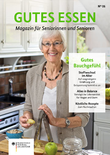 Seniorin in einer Küche beim Reiben eines Apfels für ihr Müsli