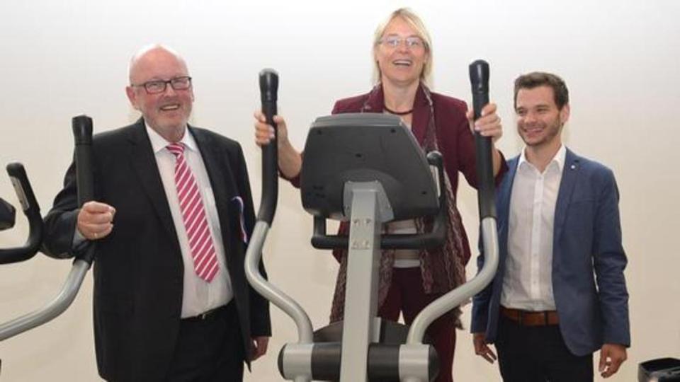 Gruppenfoto mit Ministerin Alheit auf einem Fitnessgerät.