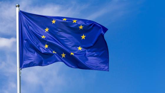 An EU flag with the sky as background